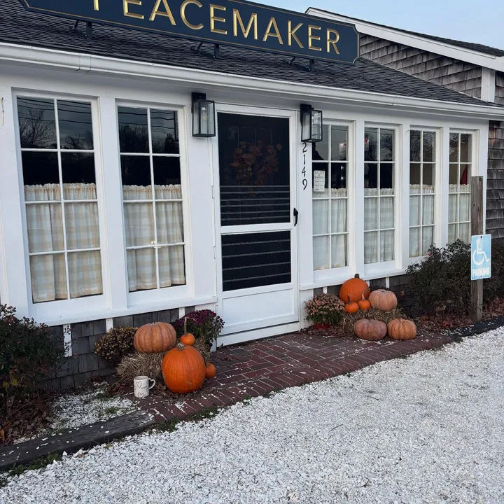 The shop doorway in autumn, pumpkins along the brick path