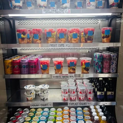 The grab-and-go cooler stocked with fruit cups, yogurts and cold drinks